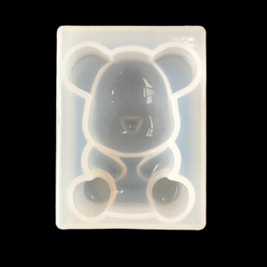 Translucent bear silicone mold for DIY resin ornaments on a solid black background
