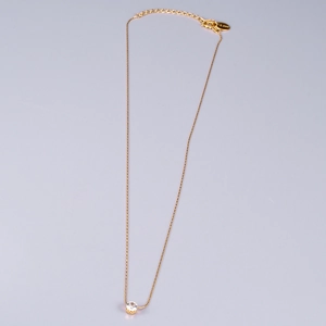 Detailed macro of bamboo chain necklace with a single six-prong cubic zirconia stone