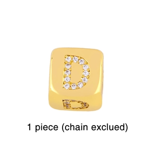 Detailed macro view of a gold plated cube charm featuring micro-paved zircon letter D