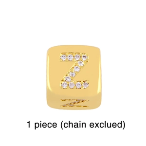Detailed macro of gold plated cube charm featuring a sparkling zircon studded letter Z