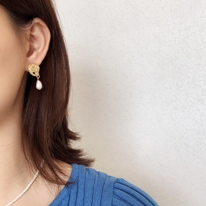 Detail of baroque pearl earrings with textured gold plating on 925 silver studs