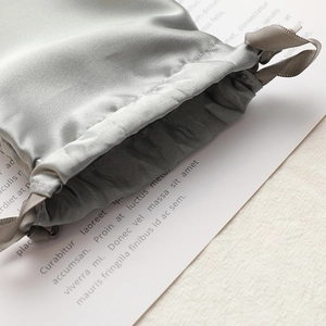 Elegant grey satin drawstring pouch with silky texture for jewelry and gift packaging
