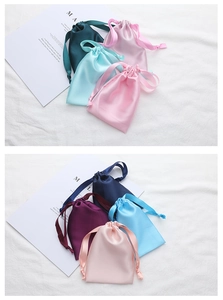Detail view of colorful silk drawstring pouches for sleep eye masks in various elegant shades