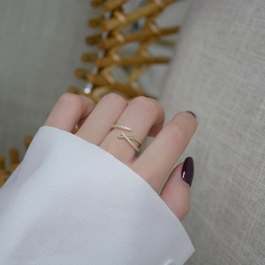 14k gold plated wrap ring with crossover cubic zirconia crystals on a model hand