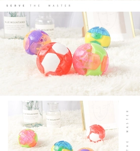 Colorful interactive pet balls with bells scattered on a soft white plush rug
