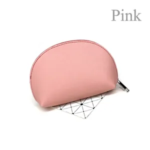 Pink semi-circle makeup bag in textured faux leather with top metal zipper closure