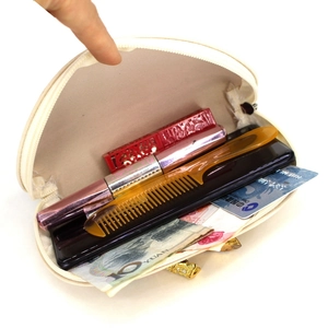 Elegant semi-circular shell-shaped makeup pouch in cream white with secure zipper closure