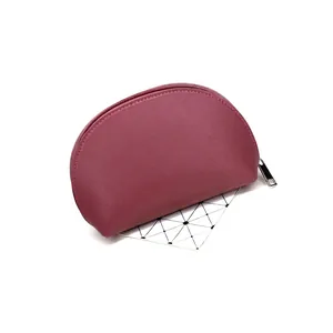 Minimalist lotus pink semi-circular PU leather clutch bag with a metallic zipper closure
