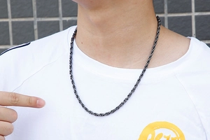 Detail shot of black braided rope chain necklace for men in polished stainless steel