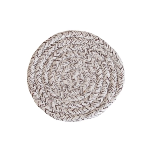 Close-up of a circular woven cotton coaster with natural beige and light brown fibers