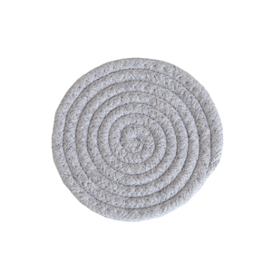Close-up of a light grey braided cotton rope coaster with a minimalist woven texture