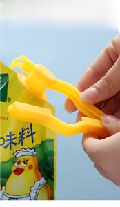 Detail of yellow plastic food bag sealer clip with spout for airtight moisture sealing