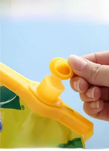 Macro shot of moisture-proof yellow plastic bag sealer with pouring spout for snacks