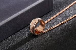 Close-up of rotatable rose gold mantra pendant necklace with P9 engraving details