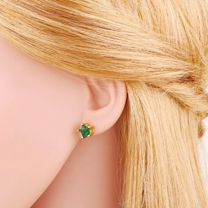 Minimalist S925 star stud earrings with green zircon on model for a trendy look