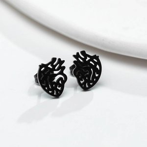 Macro shot of matte black anatomical heart stud earrings crafted from stainless steel