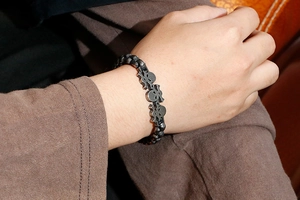 Close-up of vintage punk skull bracelet in retro silver finish worn on man's wrist