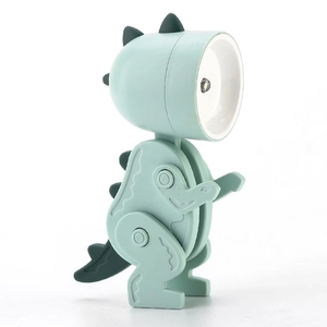 Dettaglio mini lampada LED a forma di dinosauro verde con testina rotonda su sfondo bianco