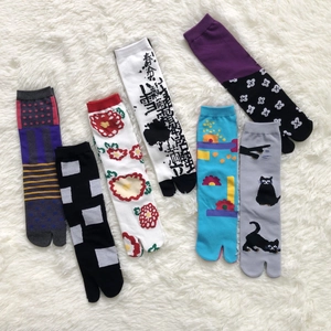 Detail shot of colorful Japanese tabi socks with carrot and floral jacquard patterns