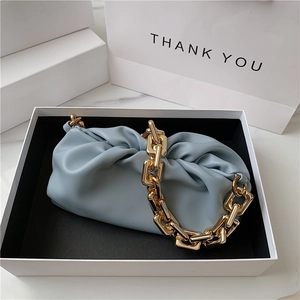 Light blue faux leather cloud bag with gold chain strap in a white gift box