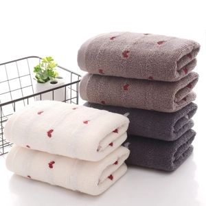Set of three thick cotton towels with red heart jacquard in white, brown and dark grey