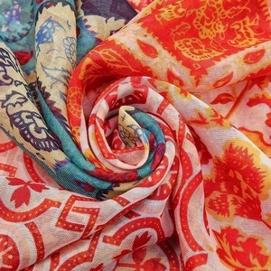 Detailed macro view of bohemian printed fabric showing ethnic patterns and breathable texture