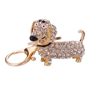 Sparkling dachshund keychain with clear crystals and golden base on white background