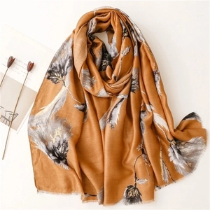 Golden yellow cotton-linen shawl with floral patterns and gold foil on a minimalist background