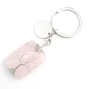 Macro shot of handmade tree of life wire wrapping on a pink quartz square pendant