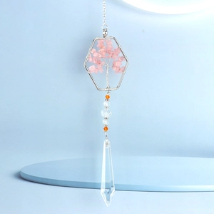 Detail of rose quartz tree of life pendant with hexagon frame and crystal prism