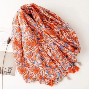 Floral cotton linen scarf with orange and blue geometric patterns and fringed tassels