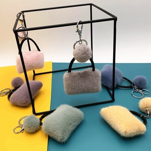 Cute plush mini bag keychains in multiple candy colors with soft fur pom pom charms