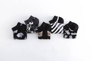Five pairs of patterned cotton casual crew socks with animal motifs and camo prints