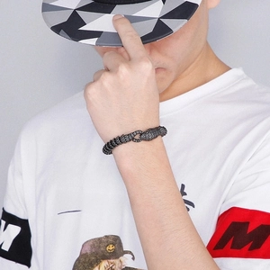 Detailed close-up of retro silver snake scale texture on a men's heavy metal bracelet