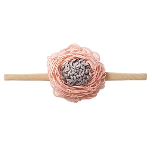 Detail of soft pink and gray fabric flower on an elastic beige nylon baby headband