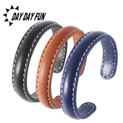 Detailed view of punk style leather bracelets in black, brown and blue with C-shape design