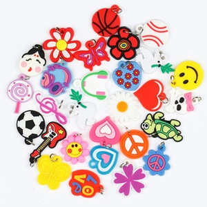 Detailed close-up of colorful PVC luggage tags featuring sports balls and heart shapes