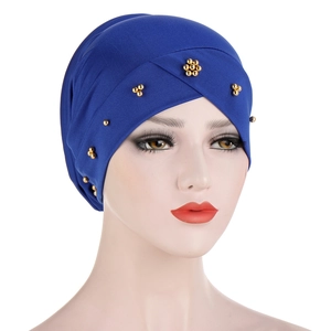 Detailed view of navy blue turban hat featuring elegant golden bead decorations