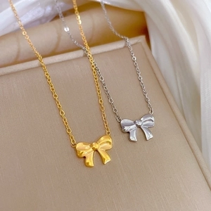 Minimalist bow tie necklaces in gold and silver finish with elegant cross chains