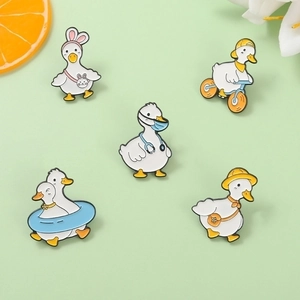 Set of five cute cartoon enamel duck brooches featuring diverse character designs