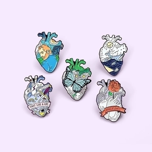 Set of five creative anatomy heart enamel pins with Van Gogh and butterfly artistic designs