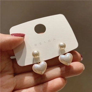 Elegant 925 silver heart pearl earrings displayed on a white product card