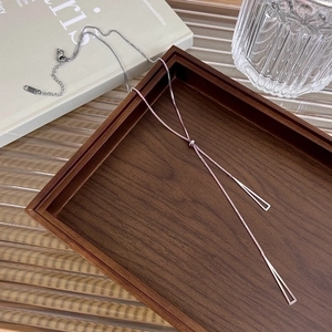 Silver titanium steel Y-shaped long sweater necklace with geometric bar pendant on wood