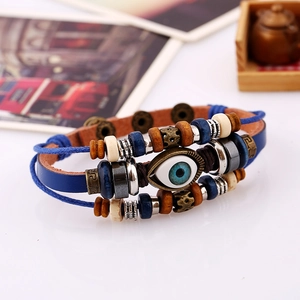 Macro shot of multi-layer leather evil eye bracelet with wooden beads and woven cords