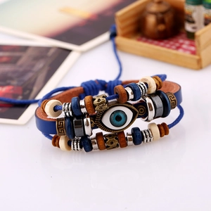 Detailed close-up of blue evil eye charm bracelet with layered leather and wooden beads