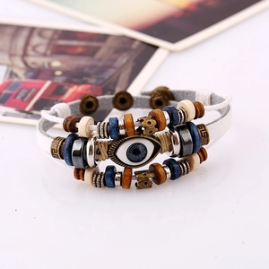 Detail shot of boho evil eye charm leather bracelet with blue wood beads and hemp rope