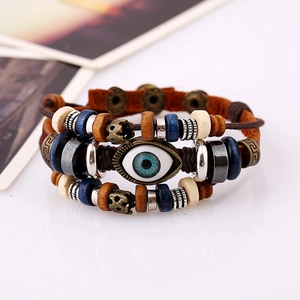 Detail of multi-layer leather bracelet with blue evil eye bead and wooden accents