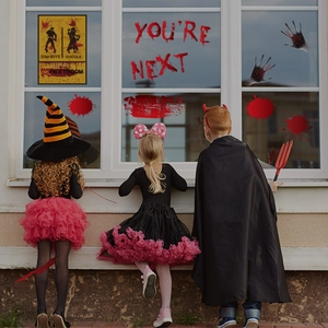 Creepy Halloween bloody handprint stickers and 'YOU'RE NEXT' decal on window display