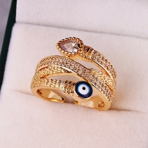 Gold evil eye wrap ring with micro-paved zircons and pear-shaped center stone