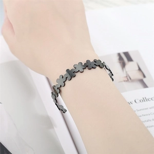 Adjustable black matte titanium steel open cuff bracelet with continuous daisy flower motifs